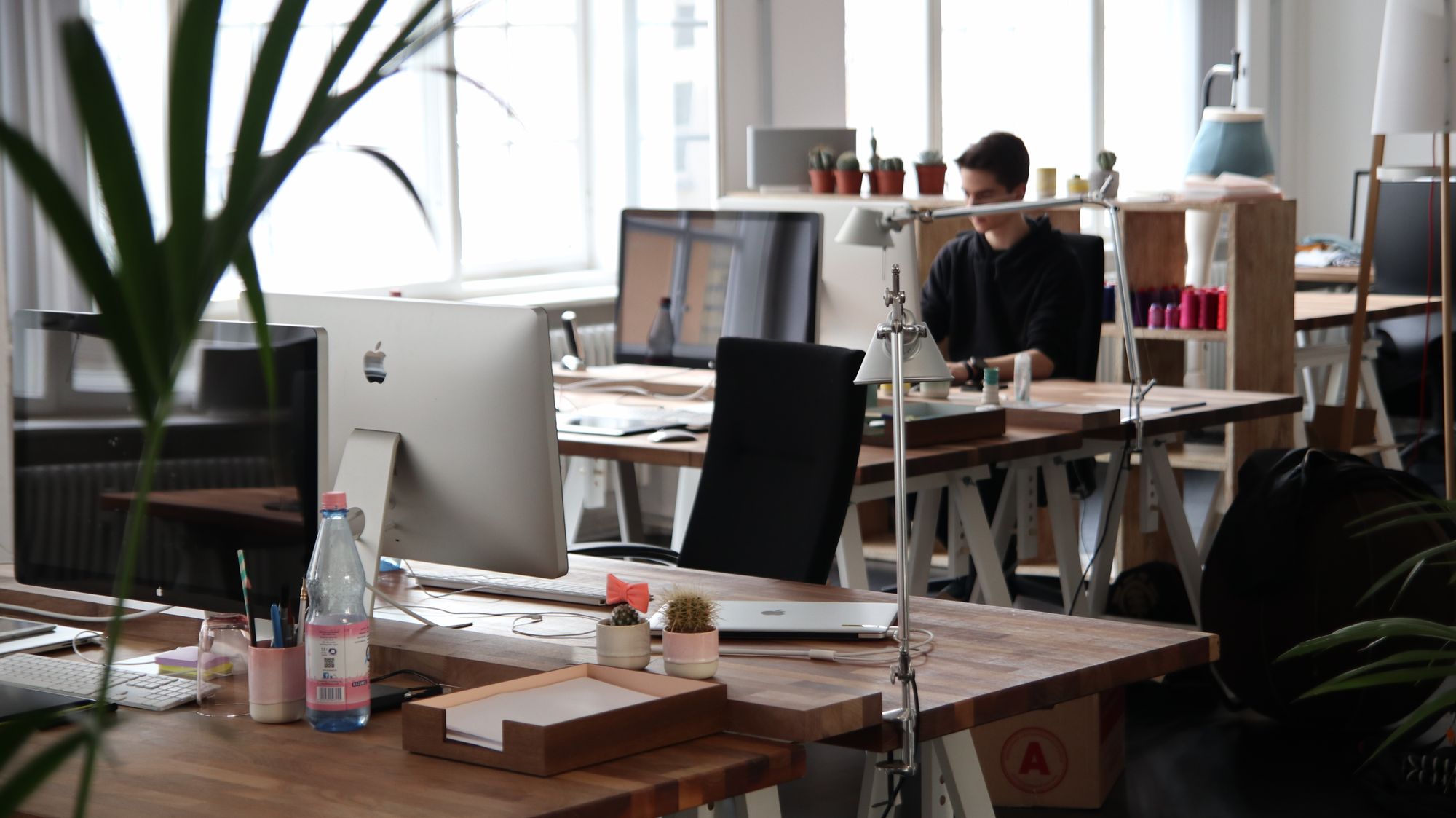 ImageMind studio interior in evening light with desks and reference boards illuminated